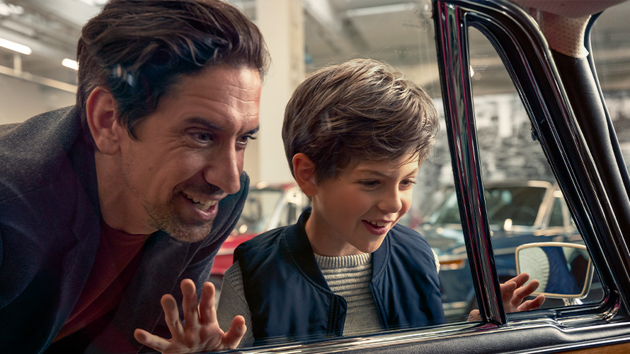 BMW Value Service Father and son marvel at the interior of a BMW classic car